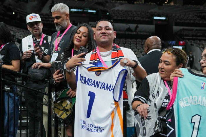 Oct 25, 2023; San Antonio, Texas, USA; Fans wait for San Antonio Spurs center Victor Wembanyama (1) to enter the court before the game against the Dallas Mavericks at the Frost Bank Center.